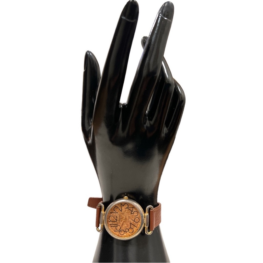 St Marin  woman tan wristband  and golden tone quartz wristwatch